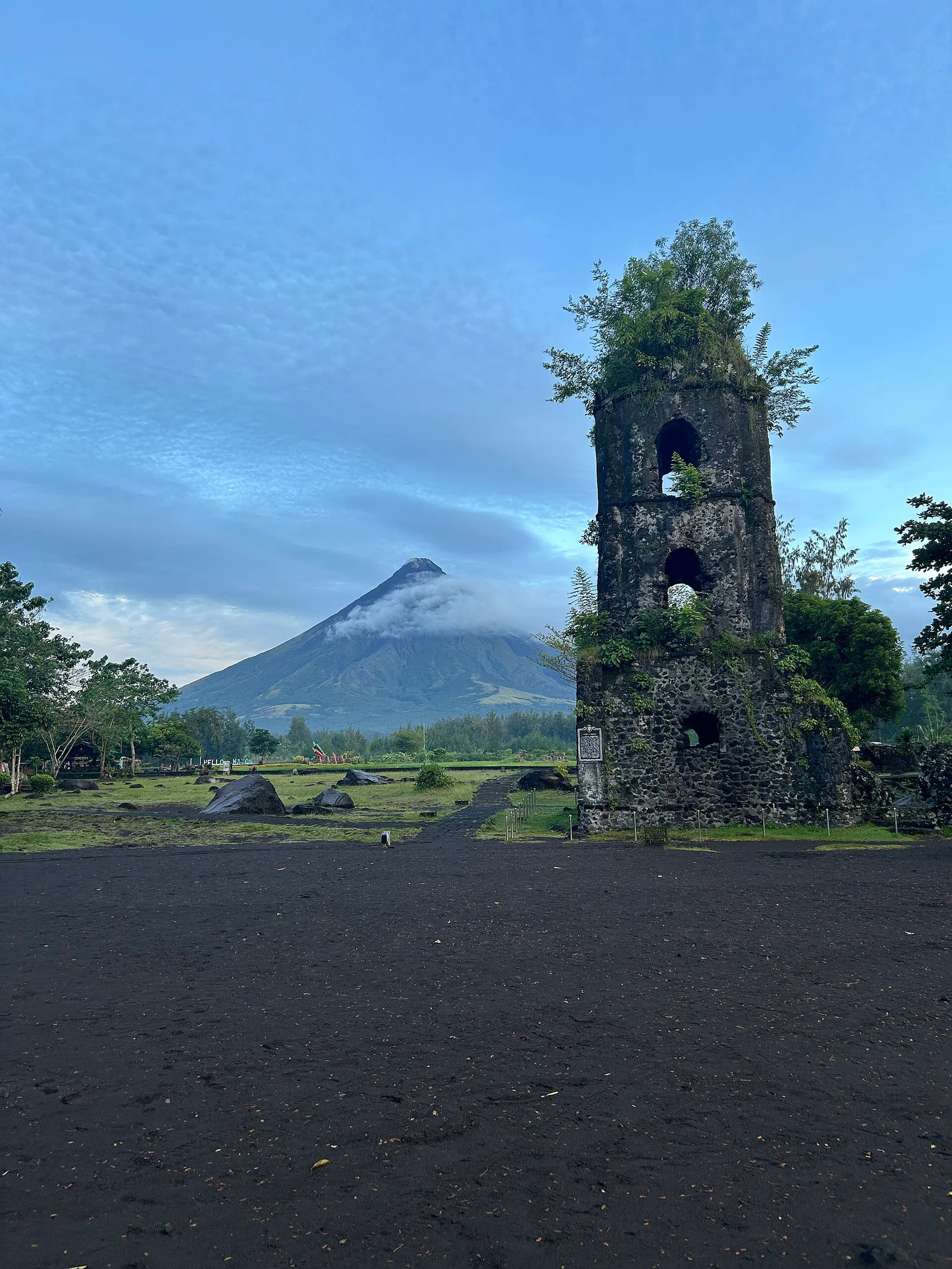 Cagsawa bell tower aligned below the green cone of Mayon Volcano