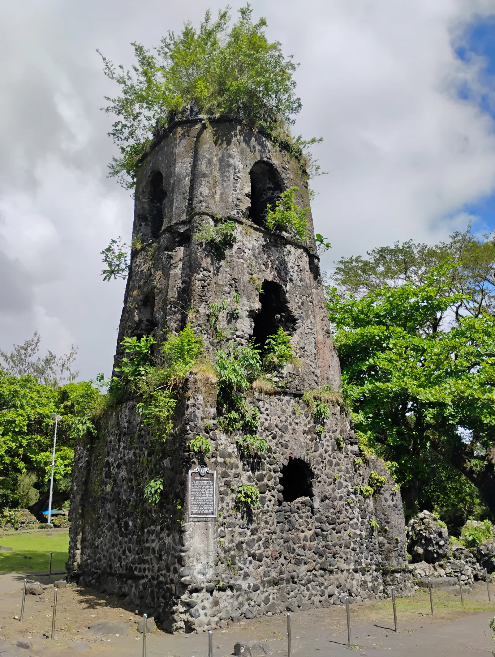 Tall bell tower seen from the green grounds of Cagsawa Ruins